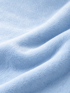 A close-up of soft, light blue plush fabric with gentle folds and a textured, fuzzy surface.