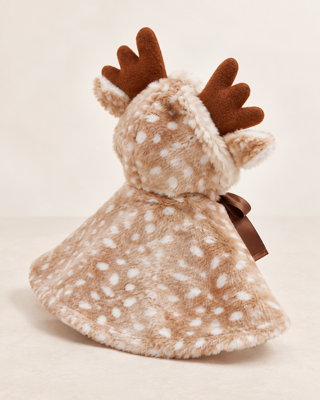 Detail view of The Reindeer Cape showing the soft spotted finish and fluffy trim.